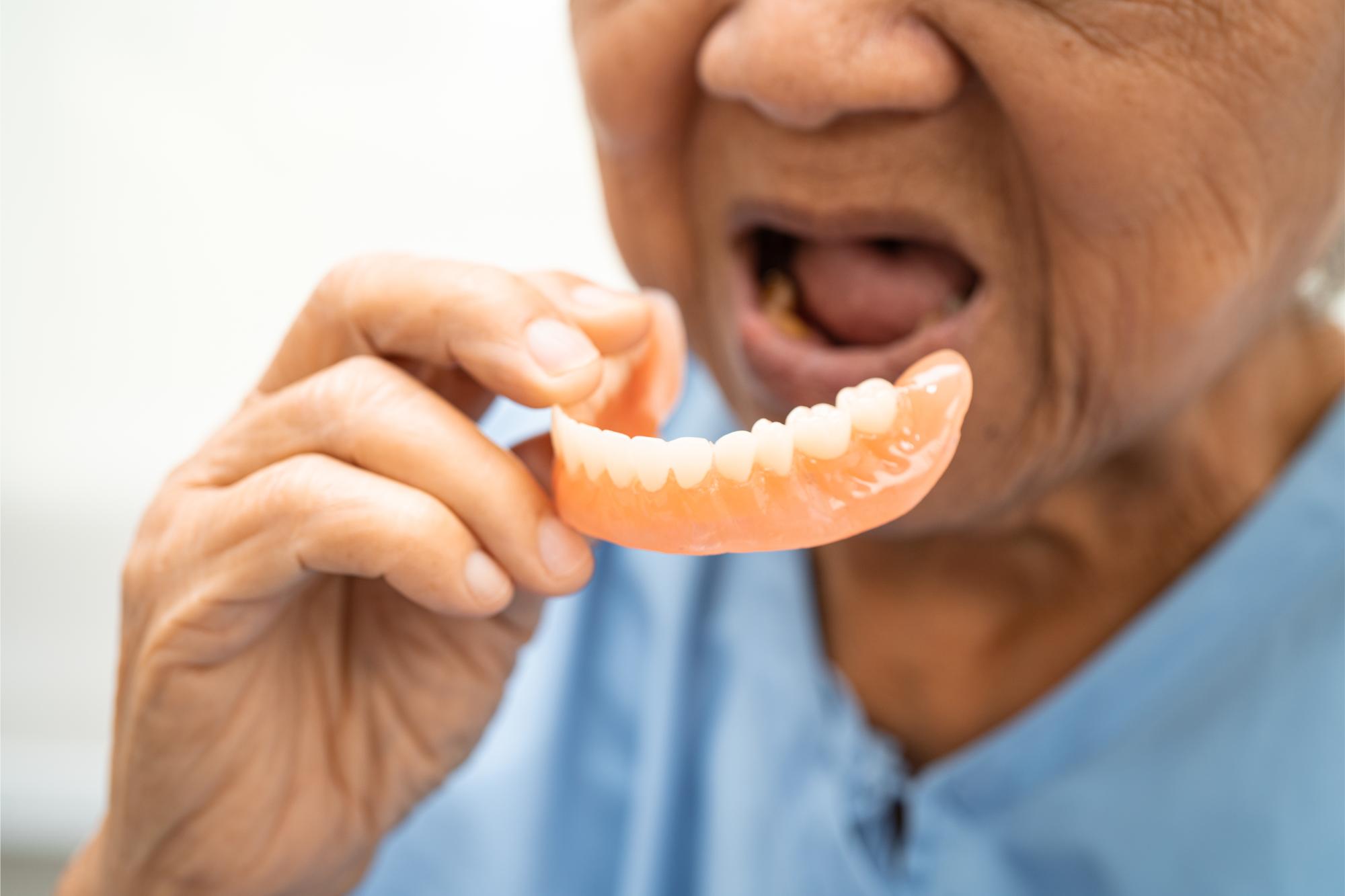 asian-elderly-woman-patient-holding-to-use-denture-2024-04-09-17-26-26-utc boca raton fl cosmetic dentist